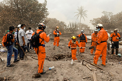 Los Topos search and rescue team dig through ashes and debris to help find missing people.