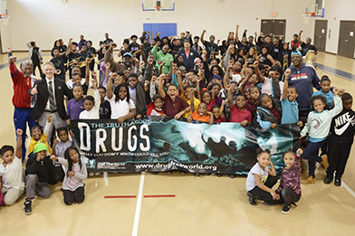 NFL (National Football League) professional athletes team up with Drug-Free World to deliver drug-education lectures in local schools in Atlanta.